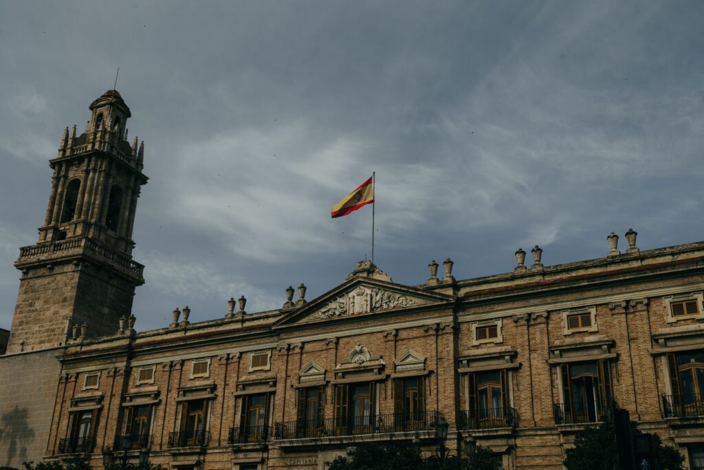 Historic Spanish government building flying the national flag