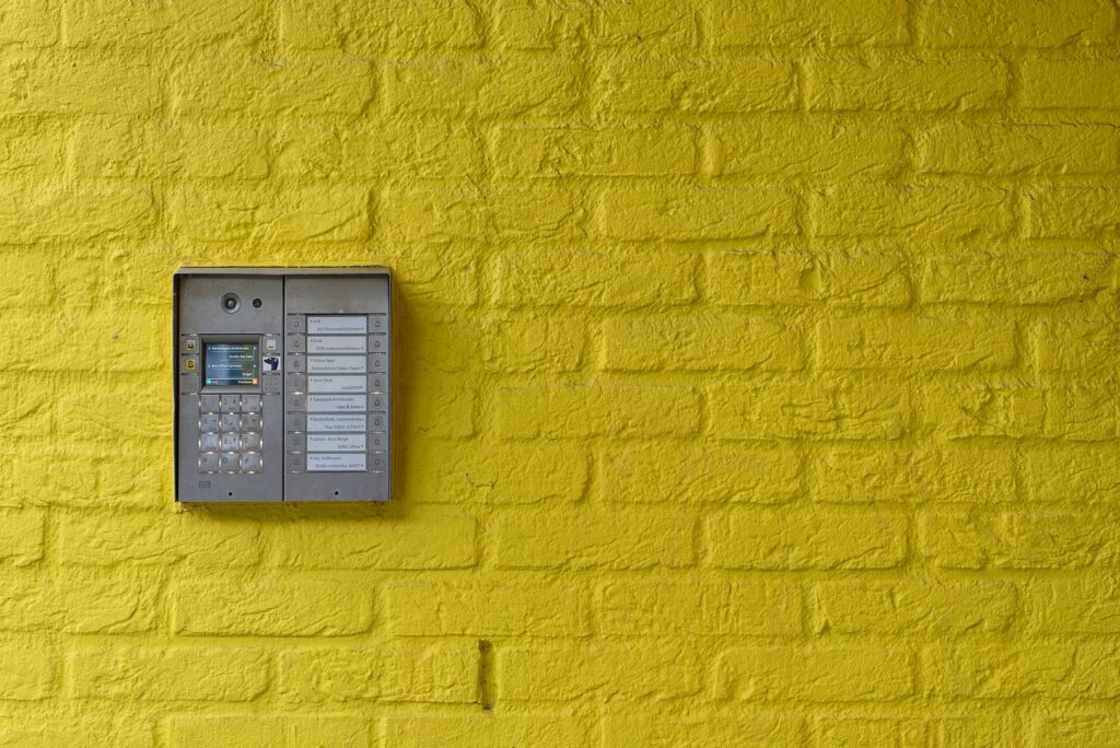Discreet intercom panel on a building entrance, typical of how cannabis social clubs are accessed